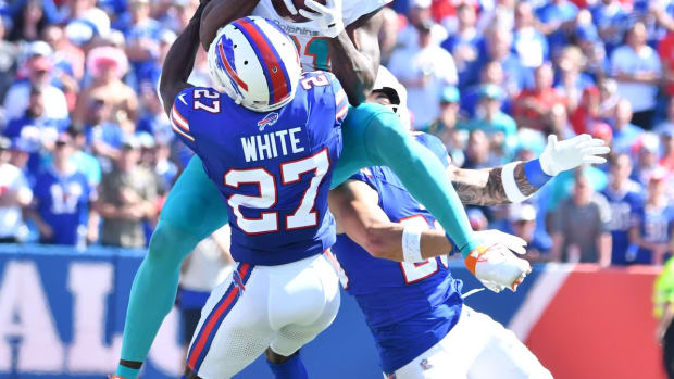 Oct 1, 2023; Orchard Park, New York, USA; Miami Dolphins running back Raheem Mostert (31) makes a catch in as Buffalo Bills cornerback Tre'Davious White (27) defends in the second quarter at Highmark Stadium. Mandatory Credit: Mark Konezny-USA TODAY Sports
